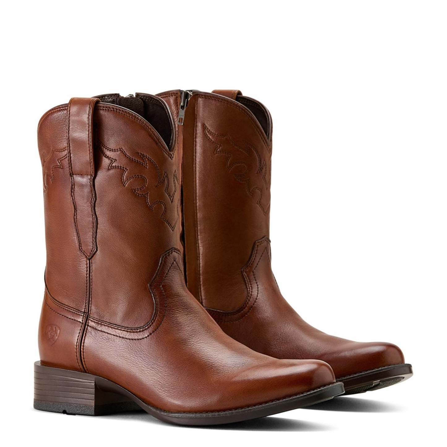 Pair of brown leather cowboy boots on a white background