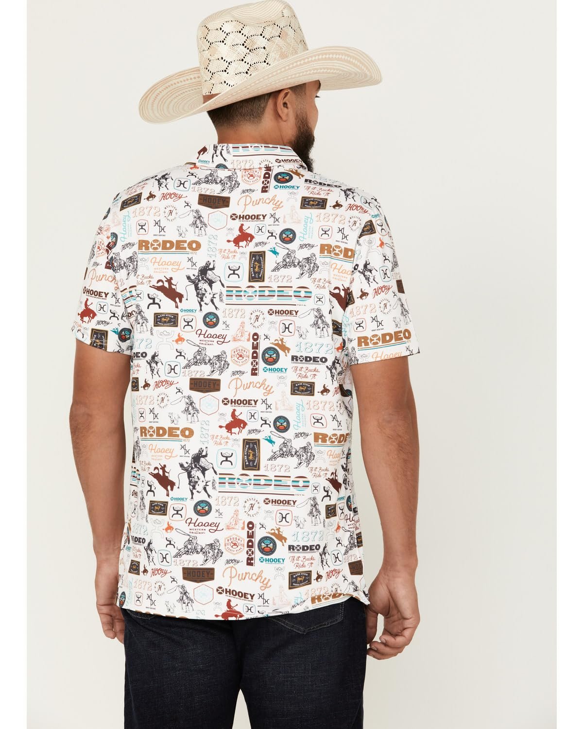 Man wearing a patterned shirt with 'rodeo' text and images, paired with a cowboy hat on a white background.