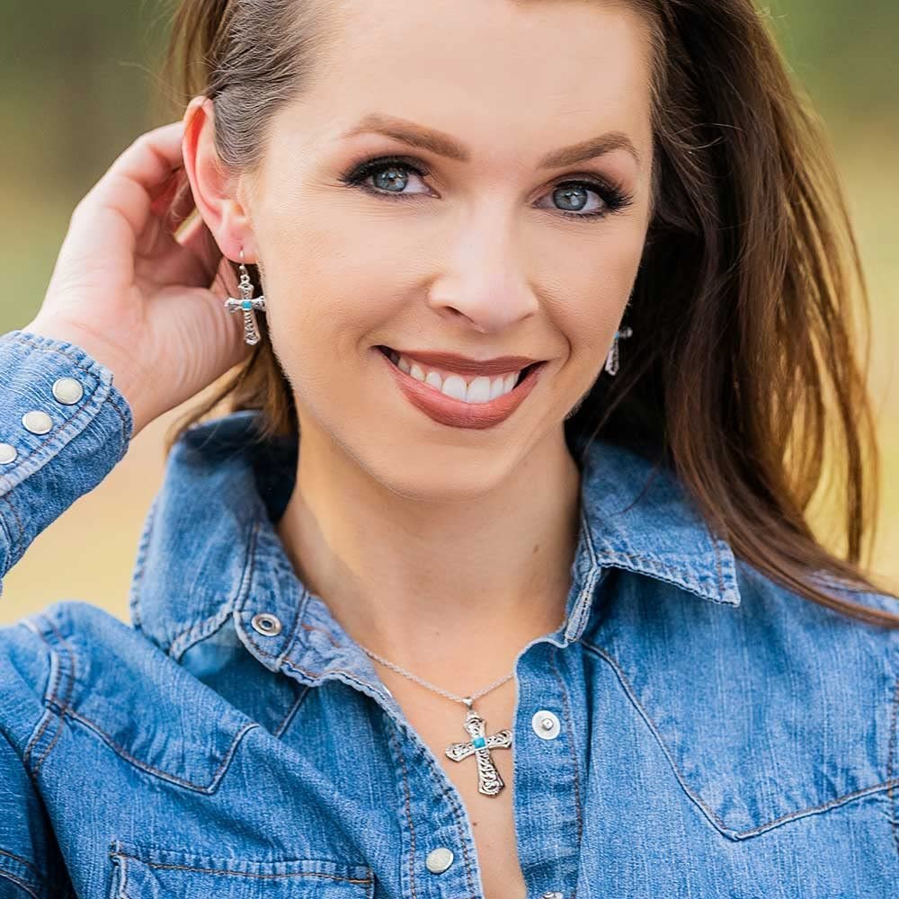 Woman Wearing Montana Silversmiths Women's Signature Necklace With Cross Pendant and Turquoise Detail, Complete With Matching Earrings