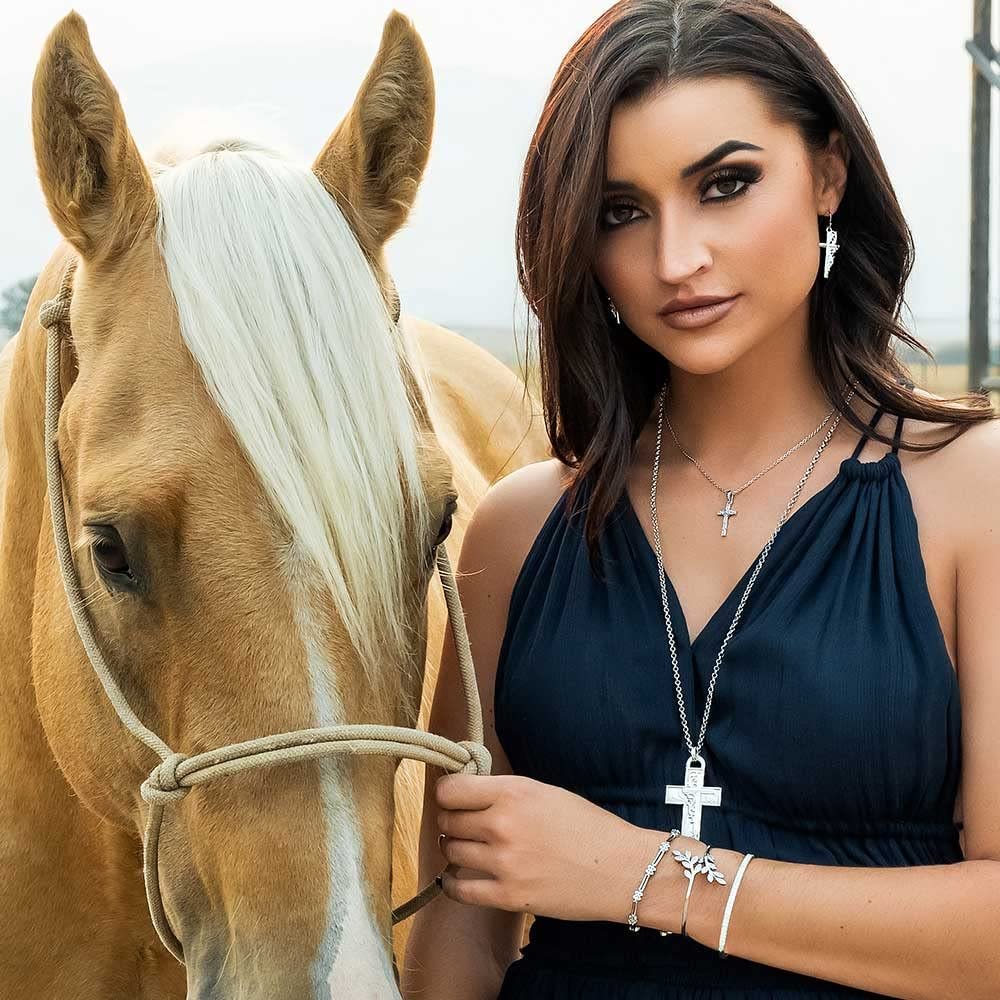 Woman Wearing Montana Silversmiths Women's Signature Necklace With Cross Pendant, Standing Next to Horse