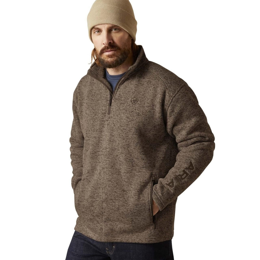 
                  
                    Man wearing a brown fleece pullover and beige beanie on a white background
                  
                