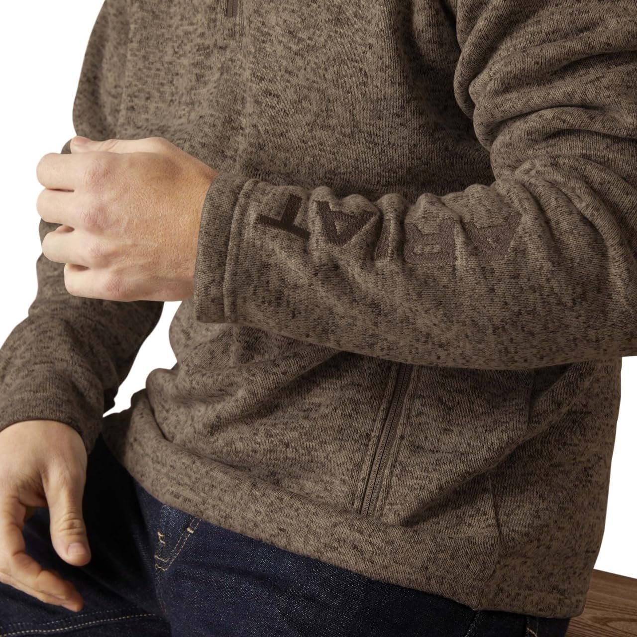 Close-up of a person wearing a brown fleece jacket with a white background