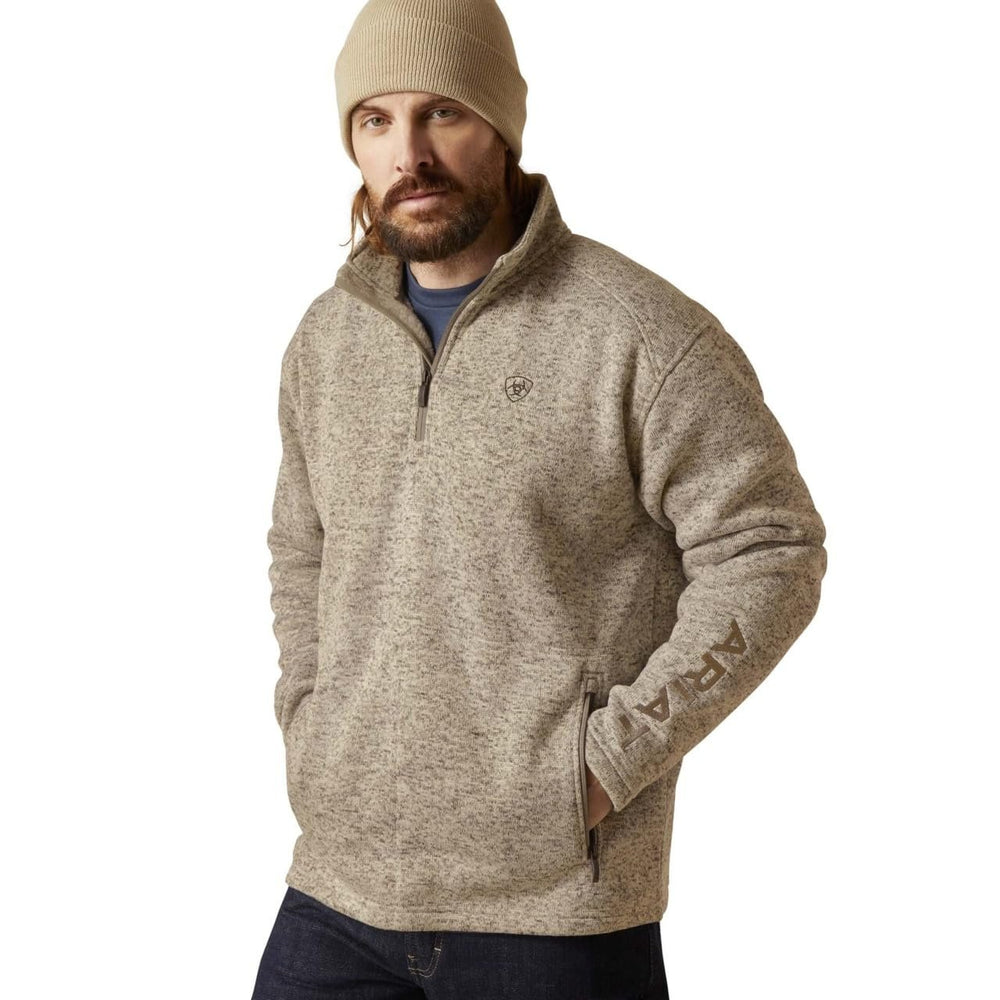 
                  
                    Man wearing a beige fleece pullover and beanie on a white background
                  
                