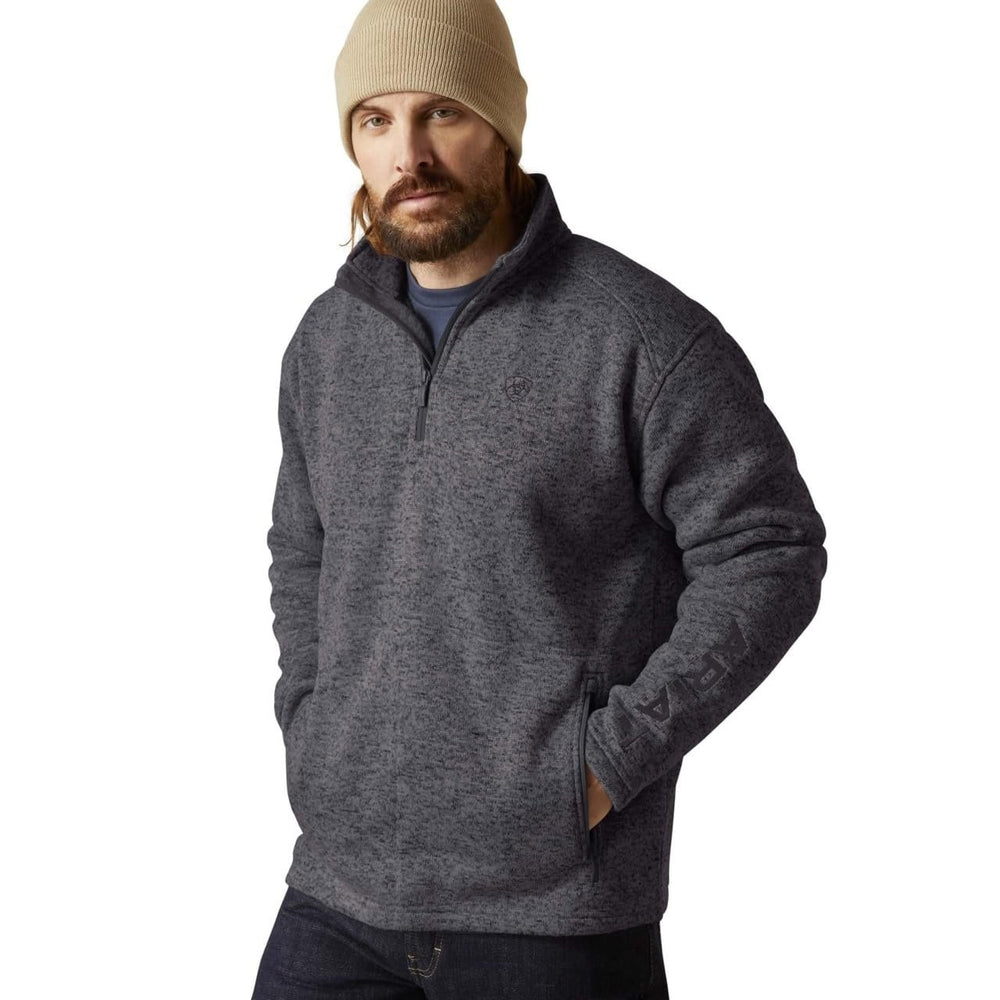 
                  
                    Man wearing a gray pullover and beige beanie on a white background
                  
                