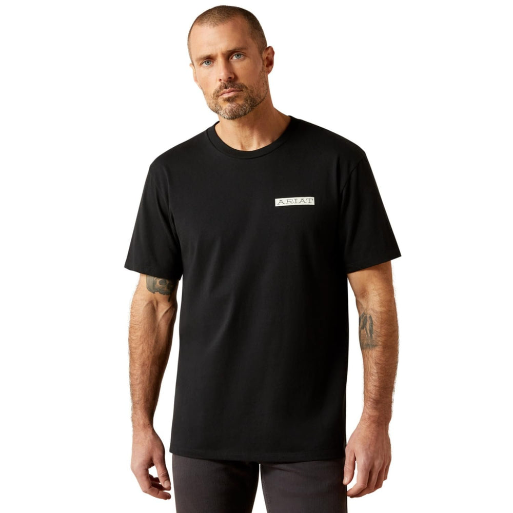 Man wearing a black t-shirt with a logo on a white background
