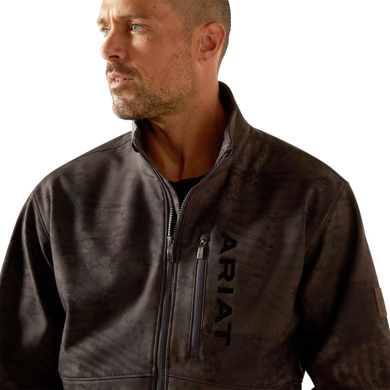 Man wearing a brown leather jacket with 'Ariat' branding on a white background
