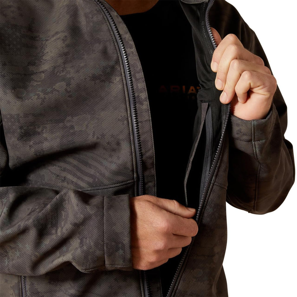 
                  
                    Person wearing a dark jacket with a brand logo on a white background
                  
                
