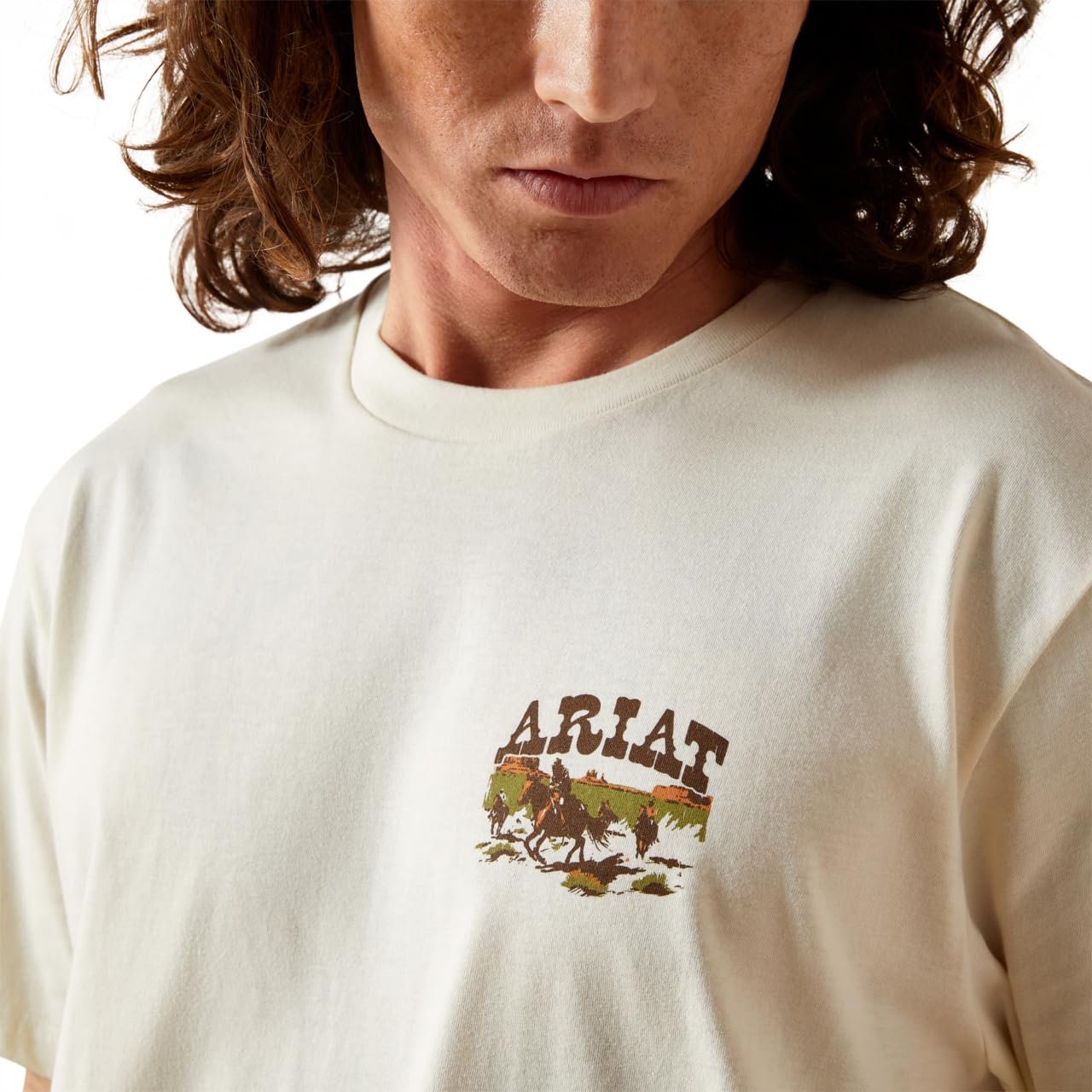 Person wearing a white t-shirt with an Ariat logo