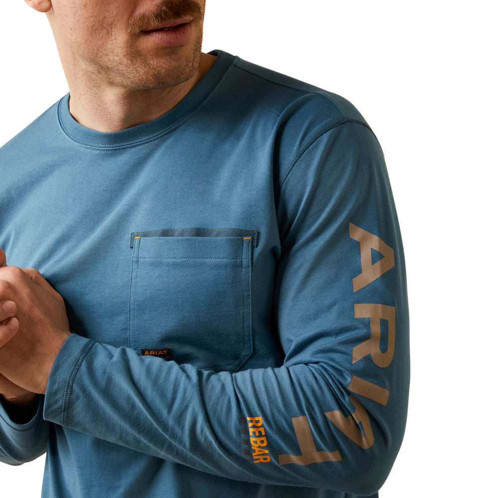 Man wearing a blue long-sleeve shirt with 'Aristocrat' branding on a white background