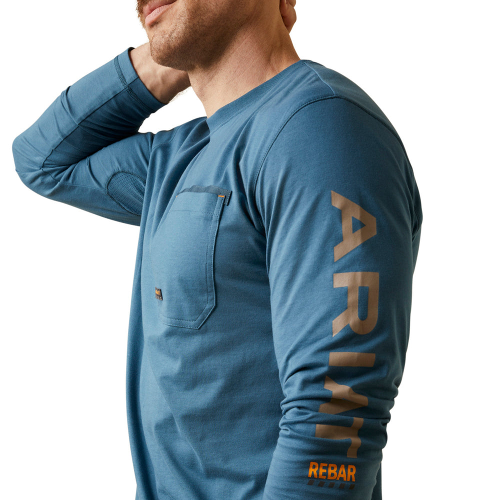 
                  
                    Man wearing a blue long-sleeve shirt with 'Rebar' branding on a white background
                  
                