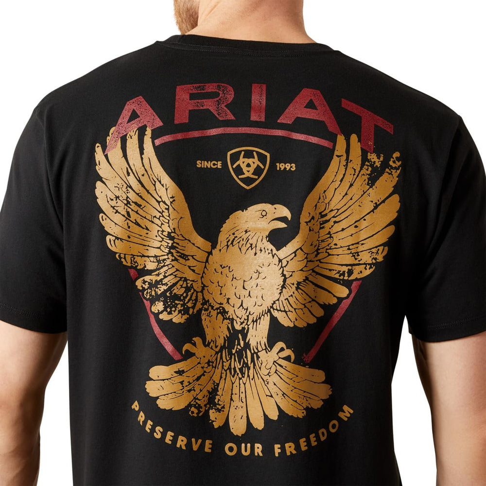 Black t-shirt with gold eagle design and 'Ariat' branding on a white background