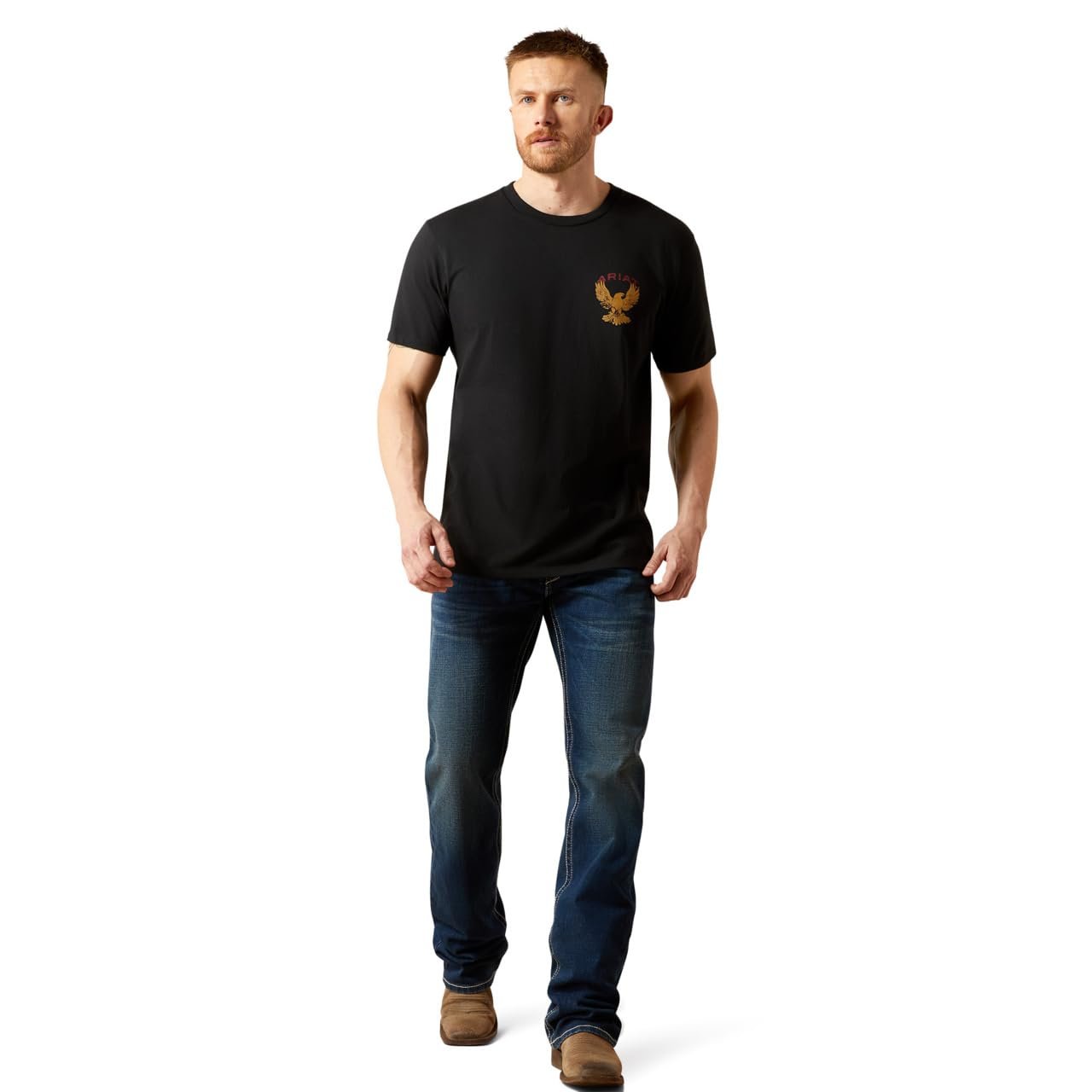 Man wearing a black t-shirt with a logo and blue jeans on a white background