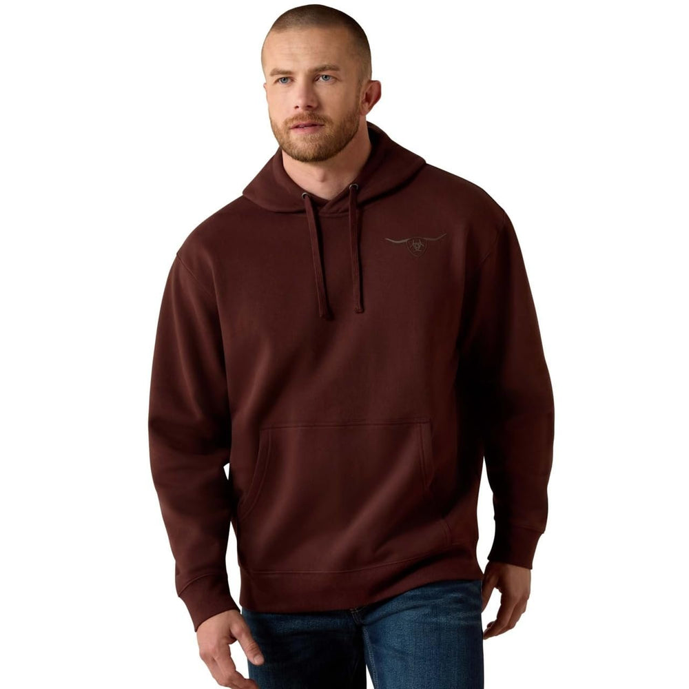 Man wearing a brown hoodie with a logo on a white background