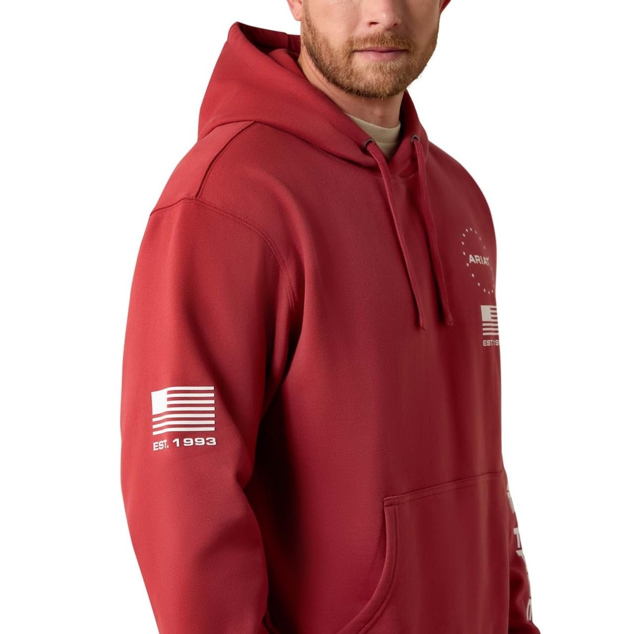 Red hoodie with white logo on sleeve worn by a person, on a white background
