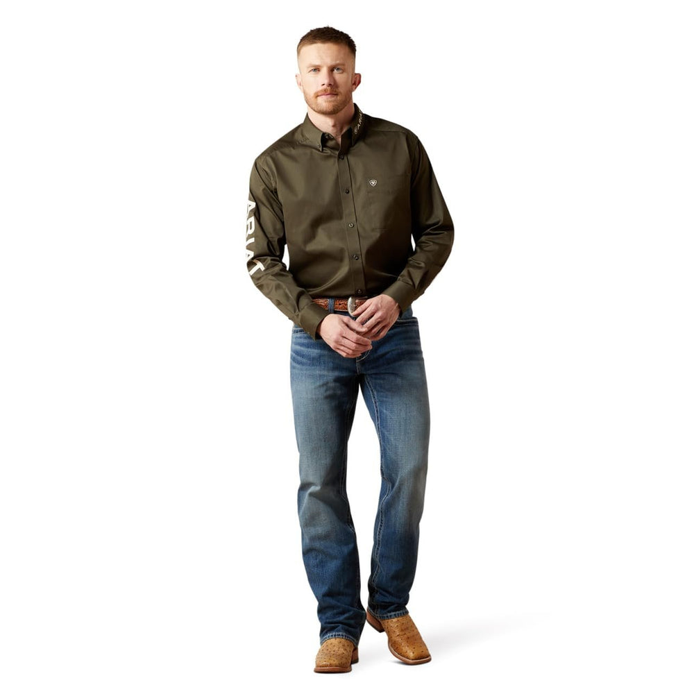 
                  
                    Man wearing a green shirt with rolled-up sleeves, blue jeans, and brown boots on a white background
                  
                