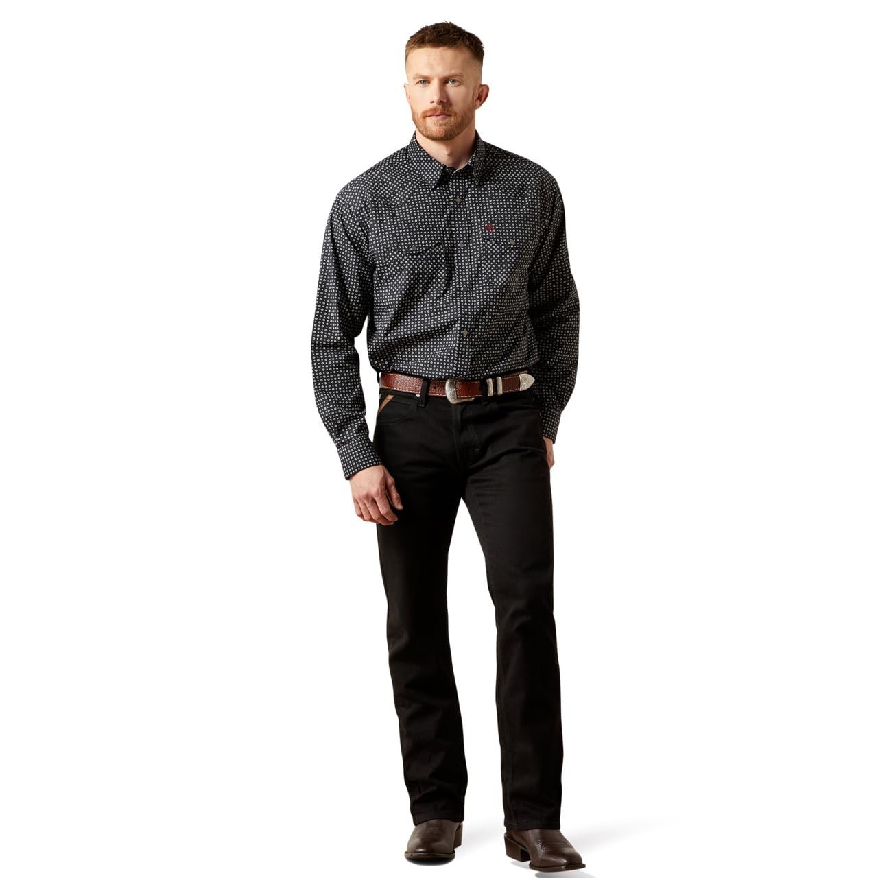 Man wearing a patterned shirt and black pants on a white background