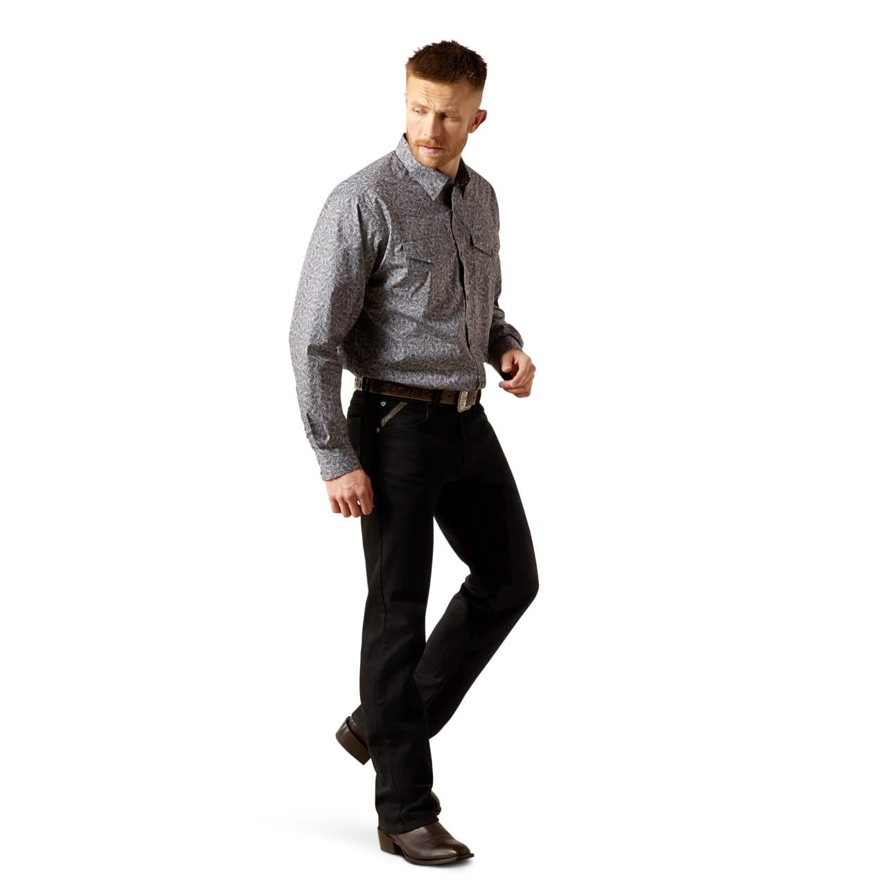 Man wearing a patterned shirt and black pants on a white background