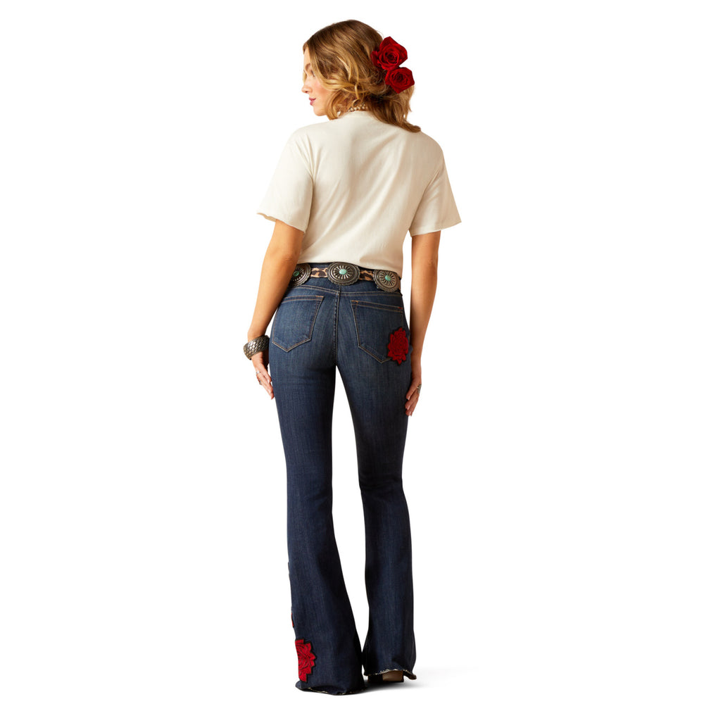 
                  
                    Woman wearing blue jeans with red accents and a white shirt on a white background
                  
                