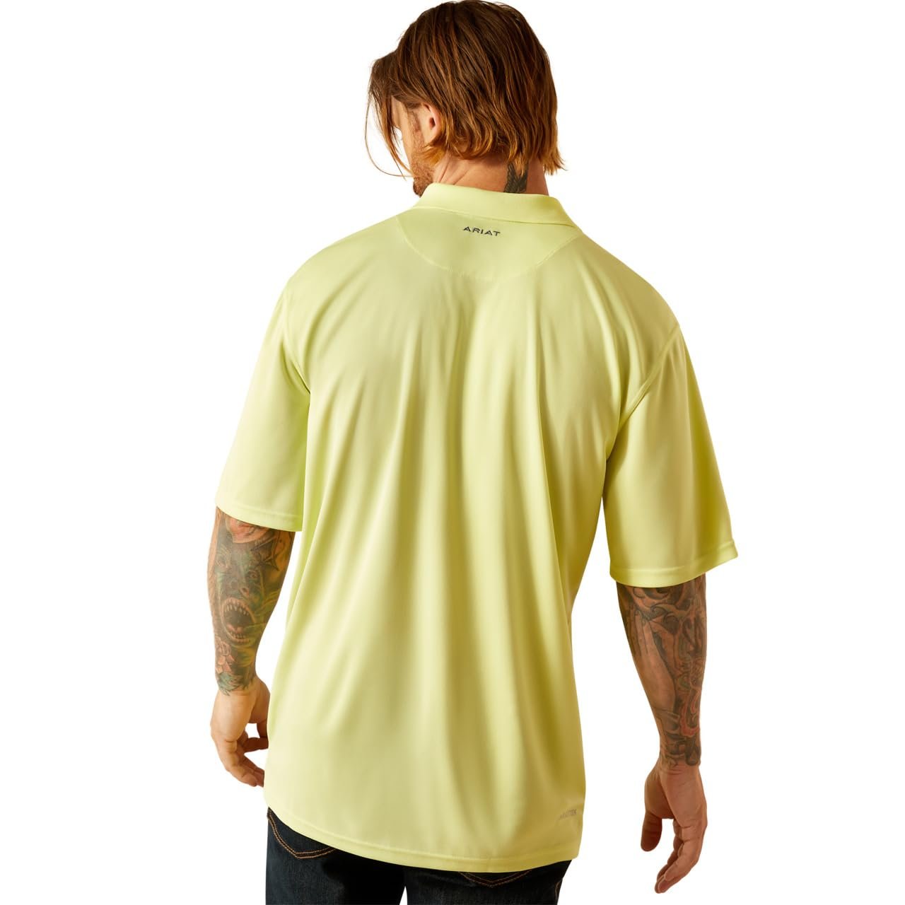 Person wearing a light yellow t-shirt with a visible brand logo on the back, standing against a white background.