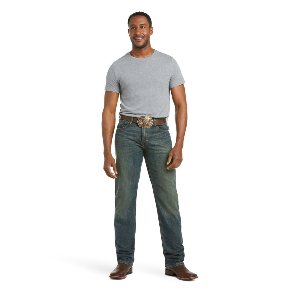 
                  
                    Man wearing a gray t-shirt and blue jeans on a white background
                  
                