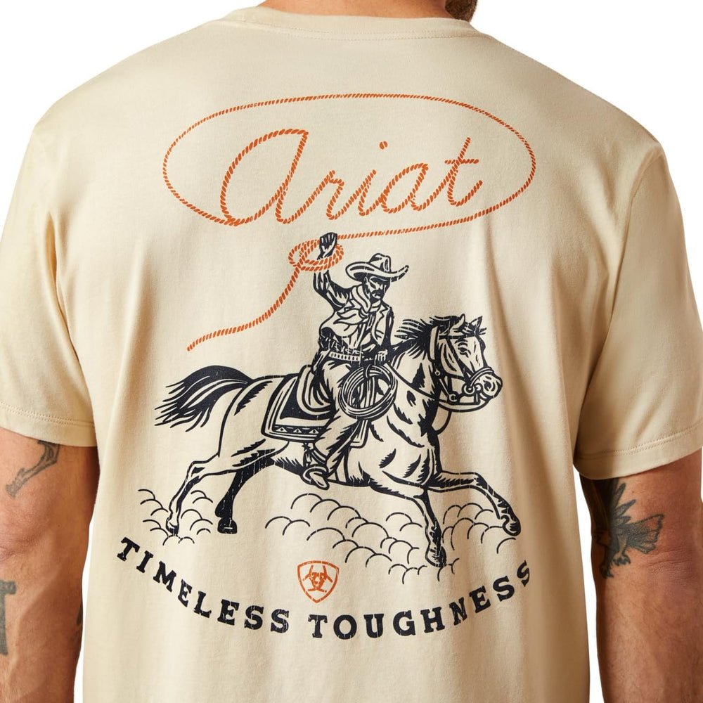 Beige t-shirt with a graphic of a cowboy on a horse and 'Ariat Timeless Toughness' text.