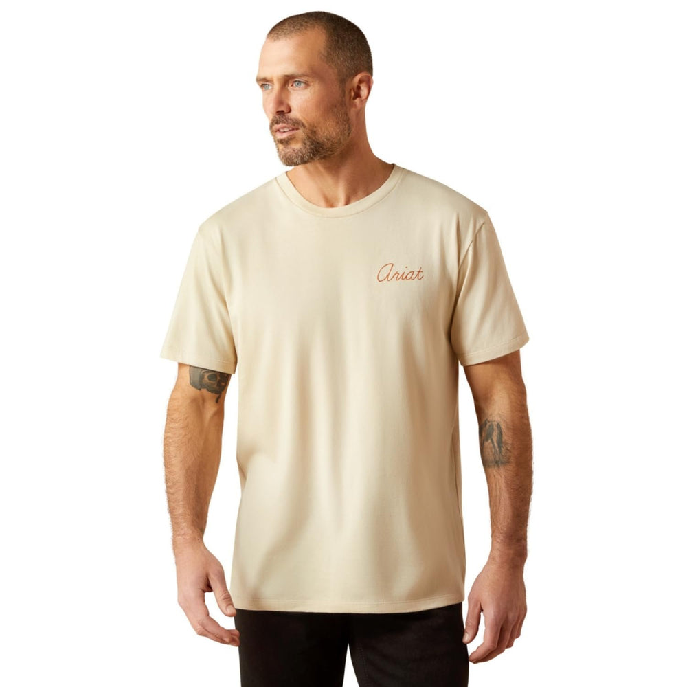 Man wearing a beige t-shirt with a logo on a white background