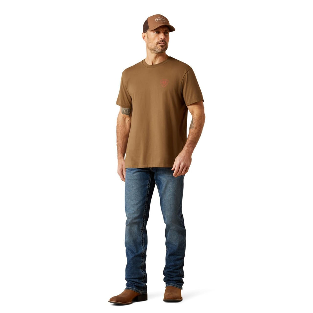 
                  
                    Man wearing a brown t-shirt, blue jeans, and a brown cap on a white background
                  
                