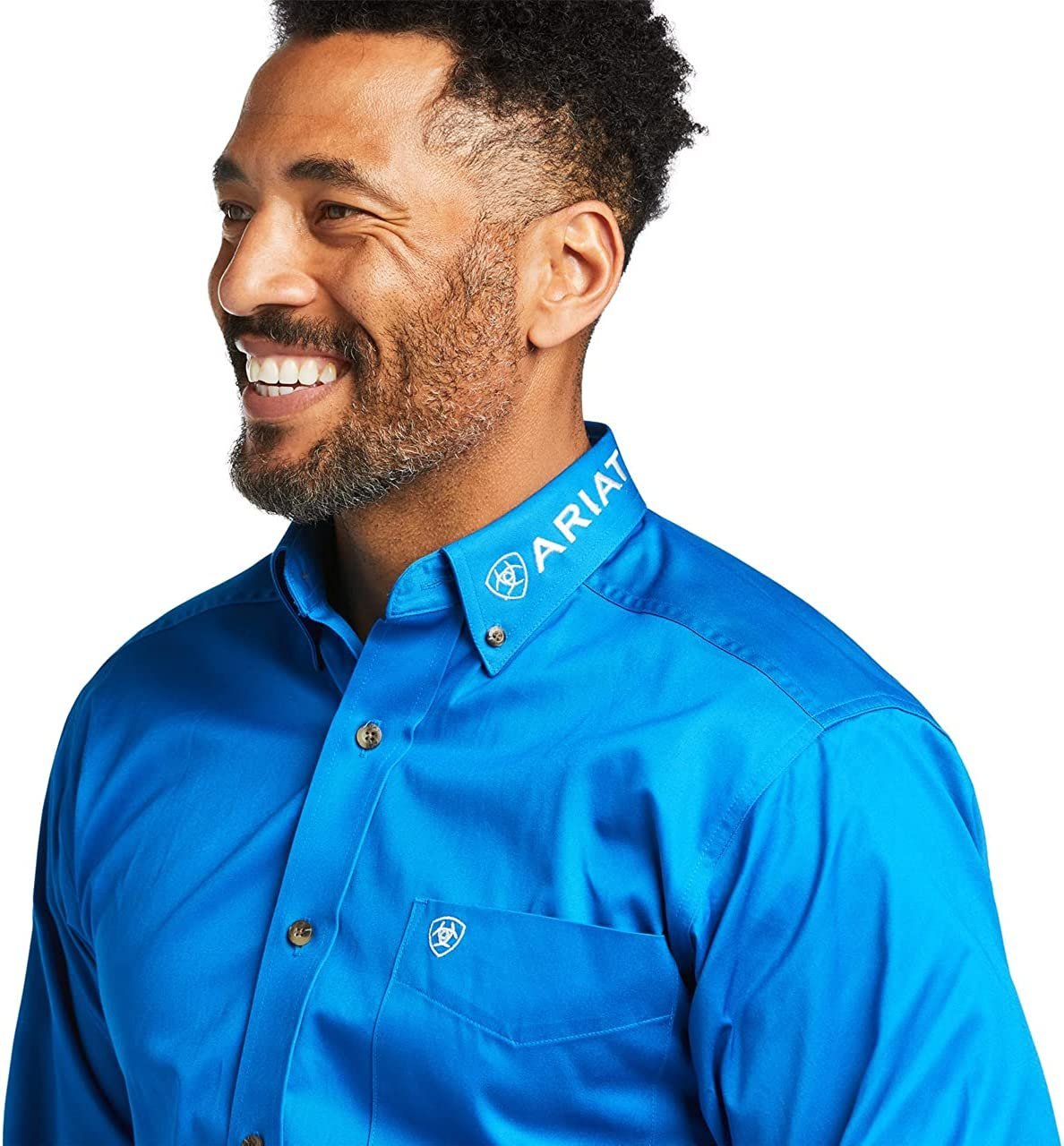 Man wearing a blue Ariat shirt on a white background