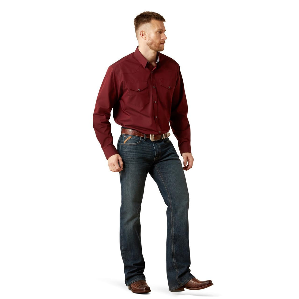 
                  
                    Man wearing a red shirt and blue jeans on a white background
                  
                