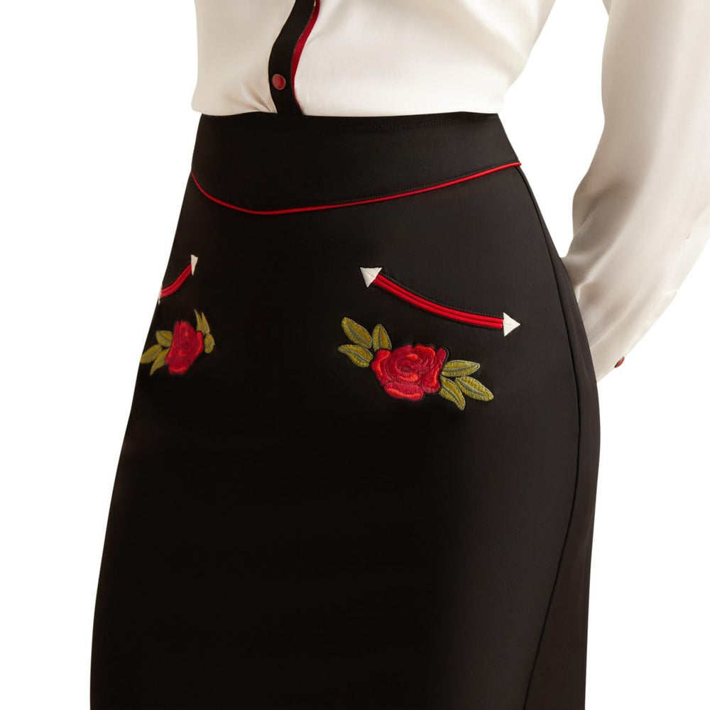 
                  
                    Black apron with red roses and green leaves embroidery on a white background
                  
                