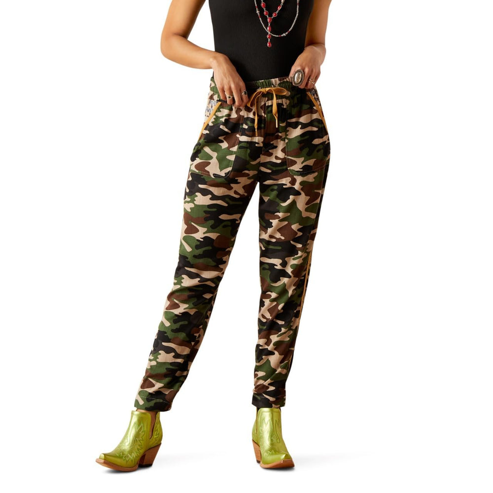 
                  
                    Camouflage pants worn by a person on a white background
                  
                