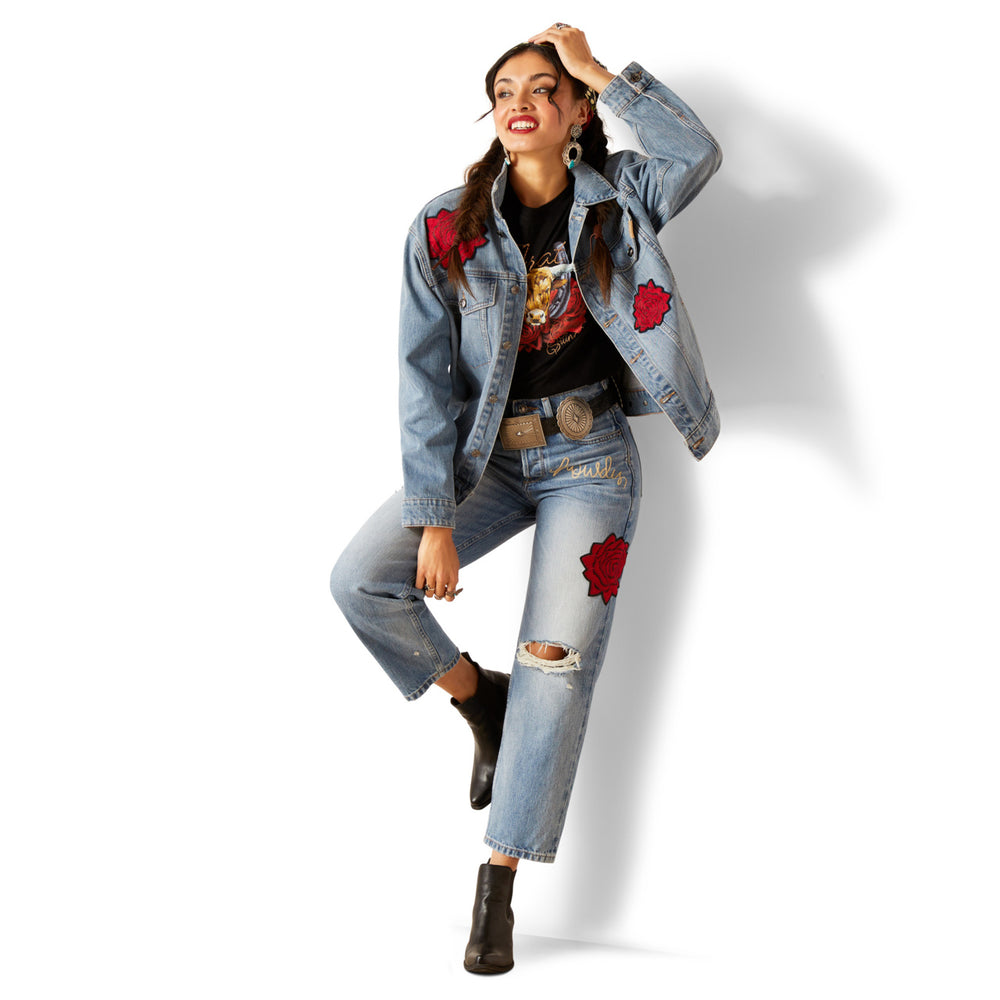
                  
                    Woman wearing a denim jacket and jeans with red patches on a white background
                  
                