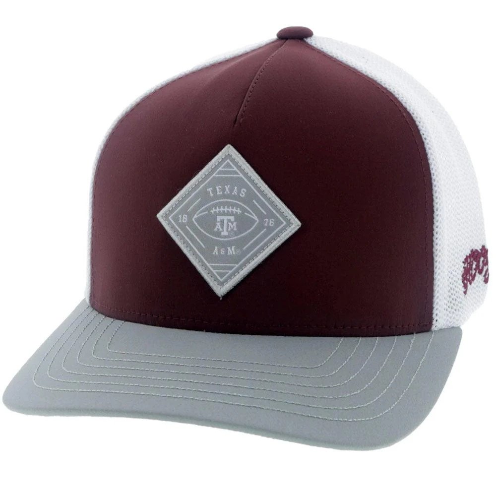 Maroon and white cap with a Texas A&M logo on a white background
