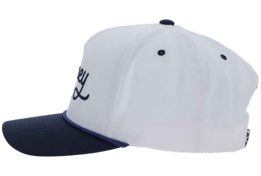 White and navy baseball cap with a logo on a white background