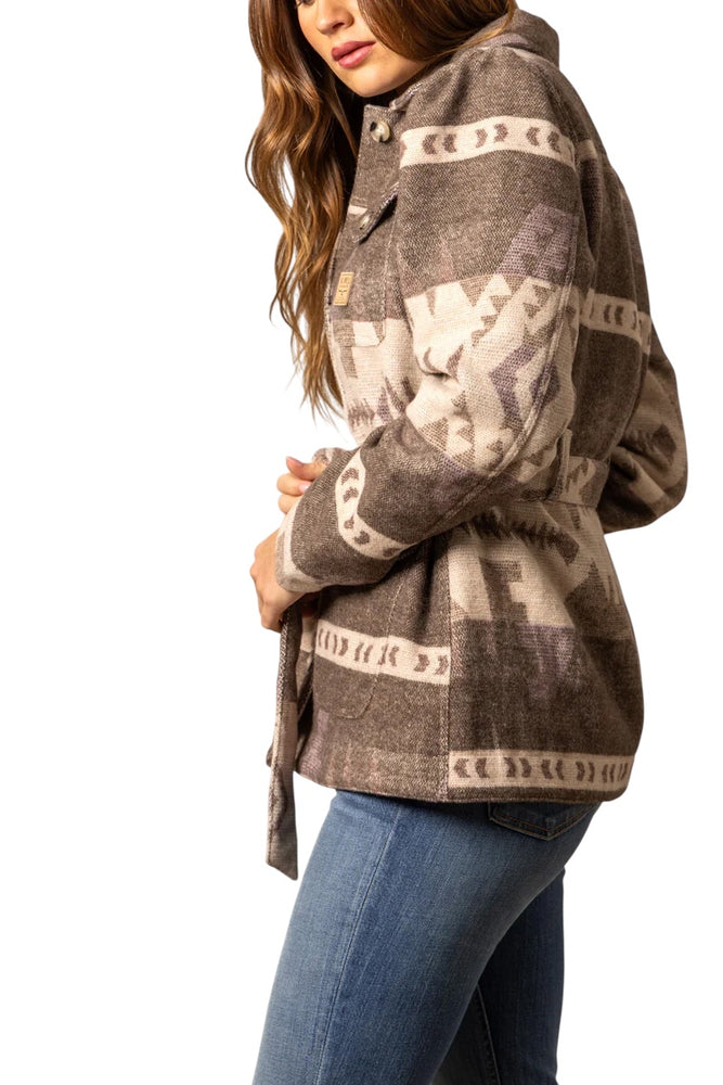 Woman wearing a patterned jacket with a white background