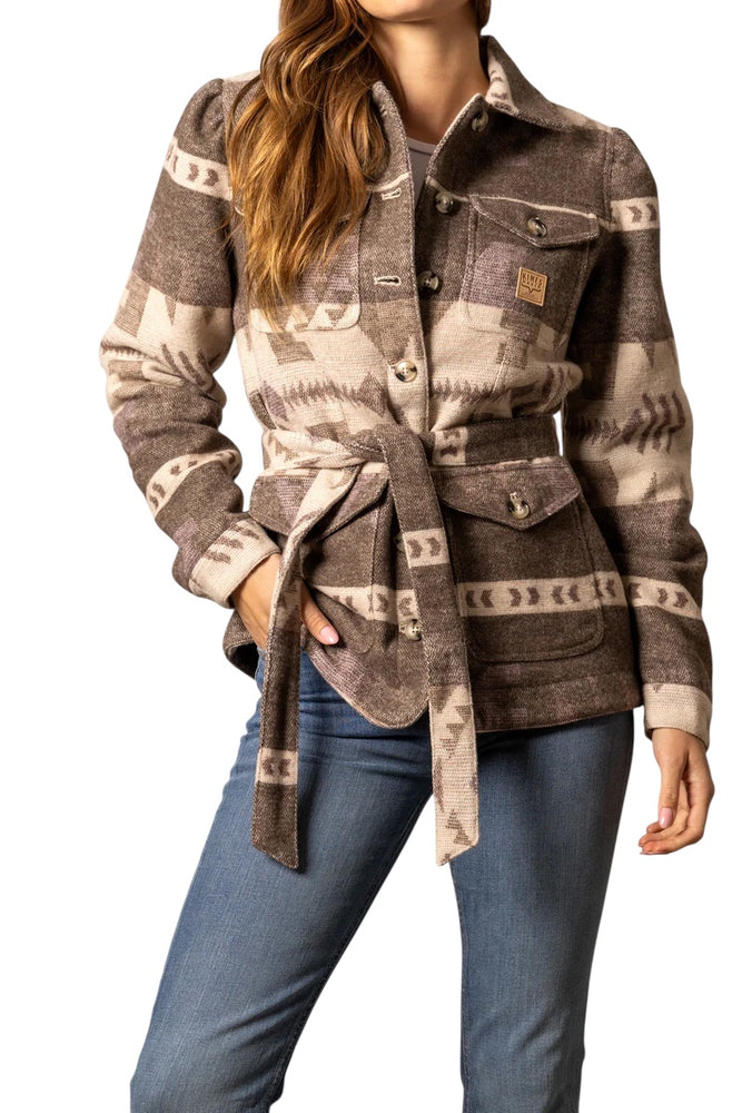 
                  
                    Person wearing a patterned jacket with a belt and blue jeans on a white background
                  
                