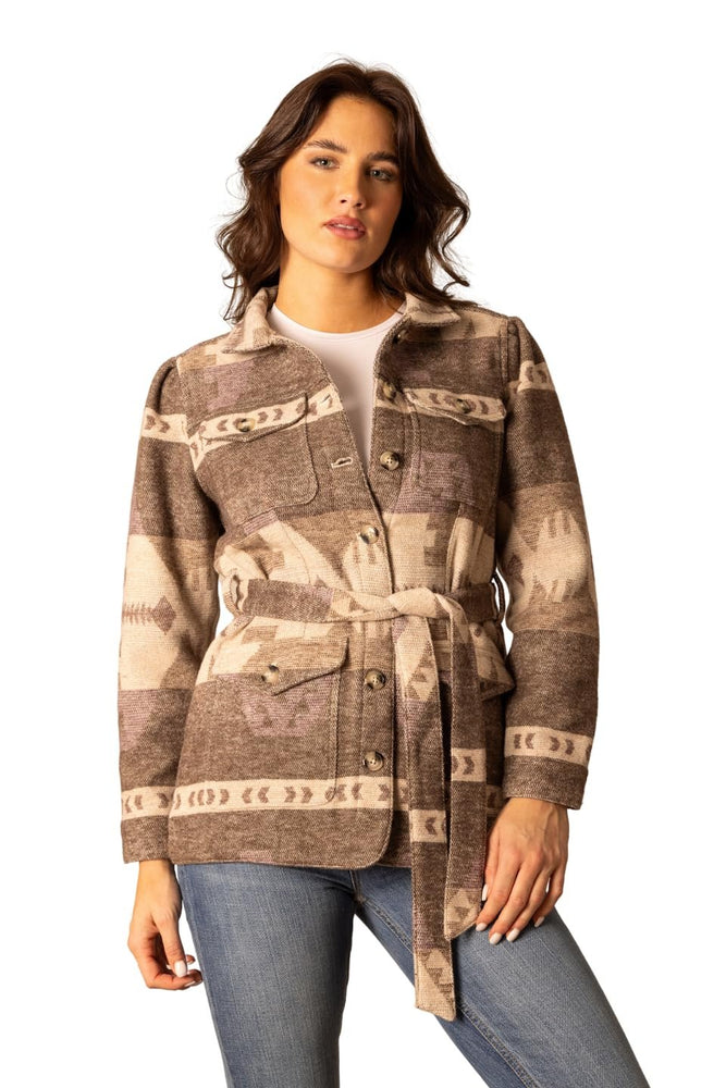 
                  
                    Woman wearing a patterned brown jacket on a white background
                  
                