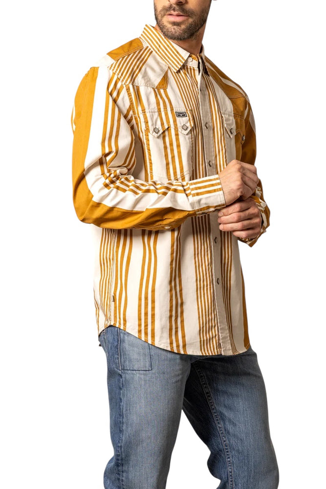 
                  
                    Man wearing a patterned shirt with mustard and beige stripes on a white background
                  
                