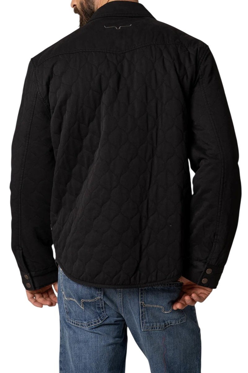 Black quilted jacket worn by a person on a white background