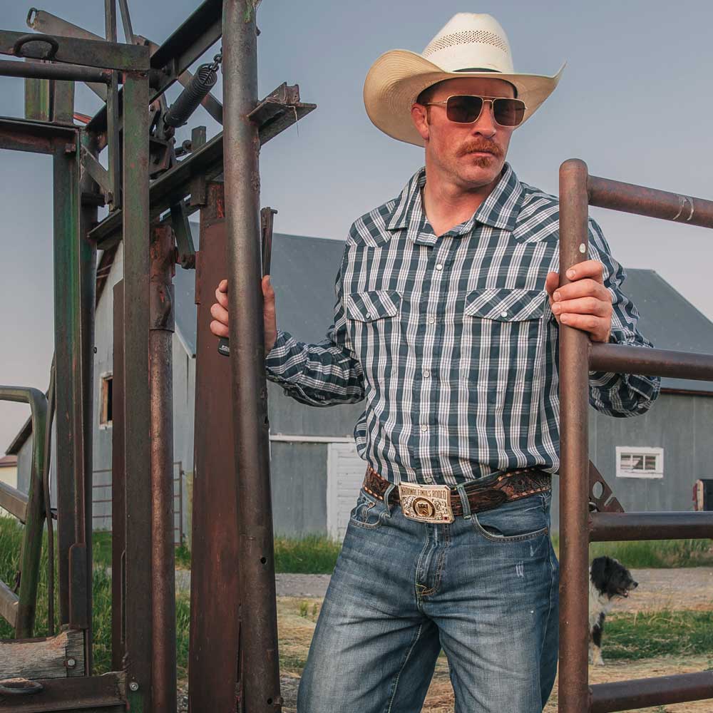 Cowboy Wearing Montana Silversmiths 2024 National Finals Rodeo Premiere Western Belt Buckle