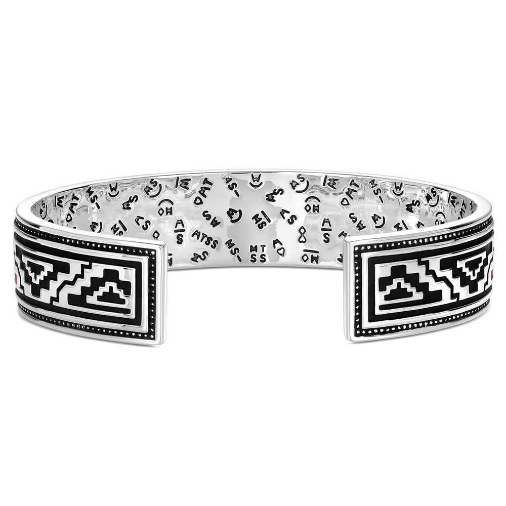 Silver bracelet with black and white geometric designs on a white background