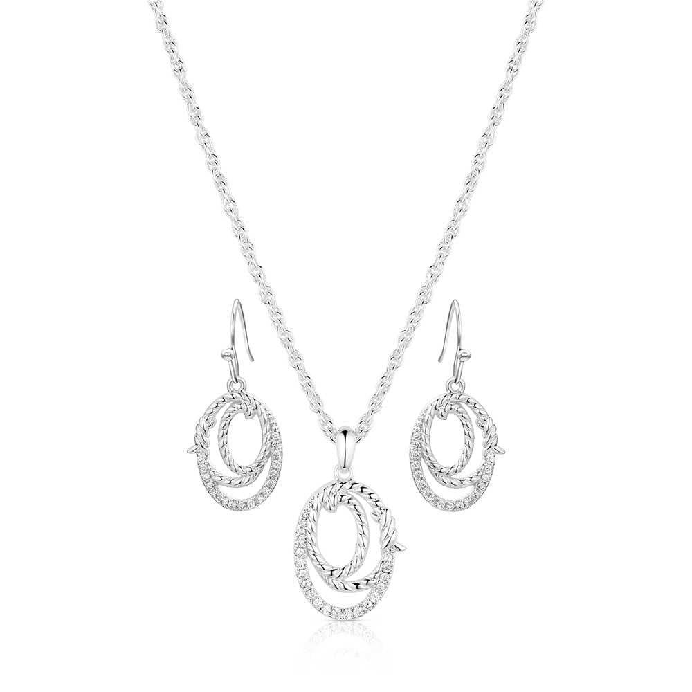 Silver necklace and earrings set on a white background