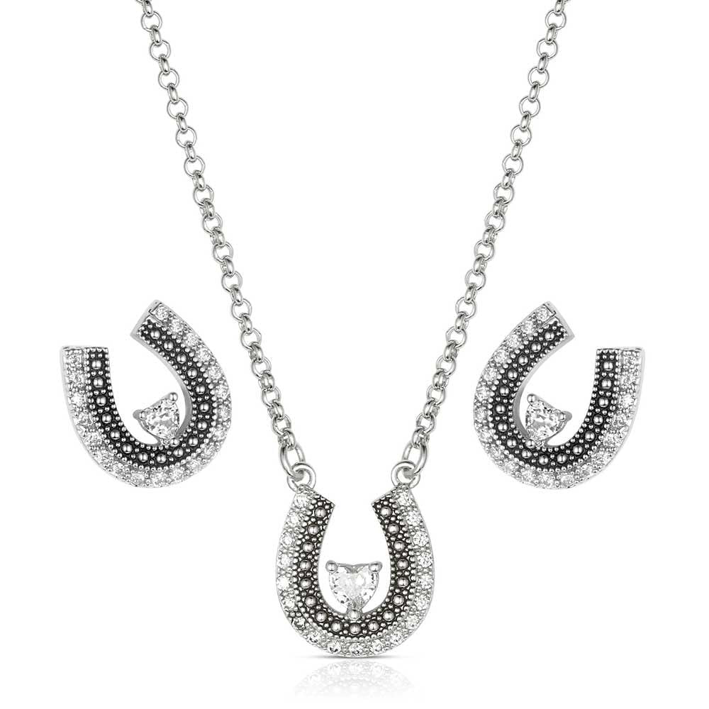Silver horseshoe necklace with diamond-like stones on a white background