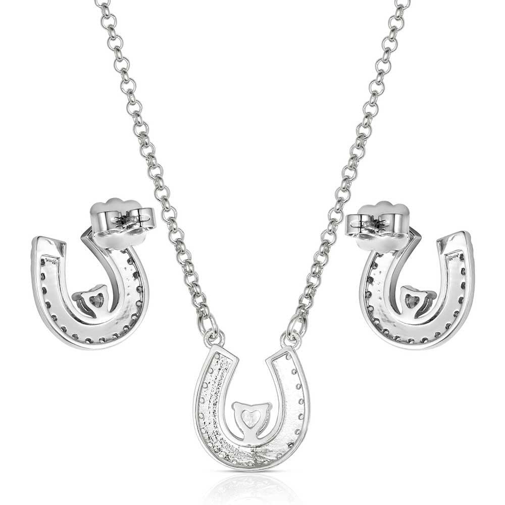 Silver horseshoe necklace and earrings set on a white background