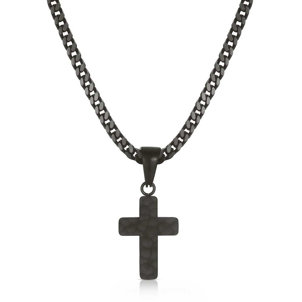 Black cross pendant on a chain against a white background
