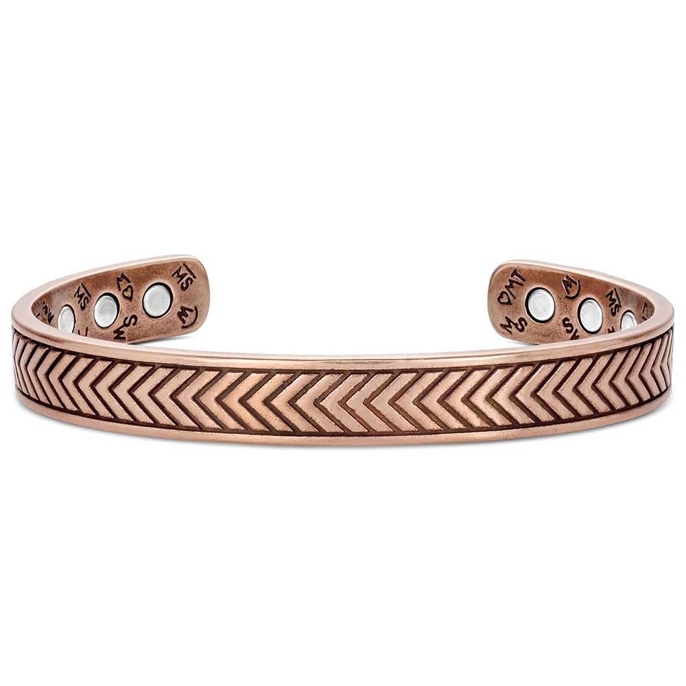 
                  
                    Copper bracelet with chevron pattern and engraved design on a white background
                  
                