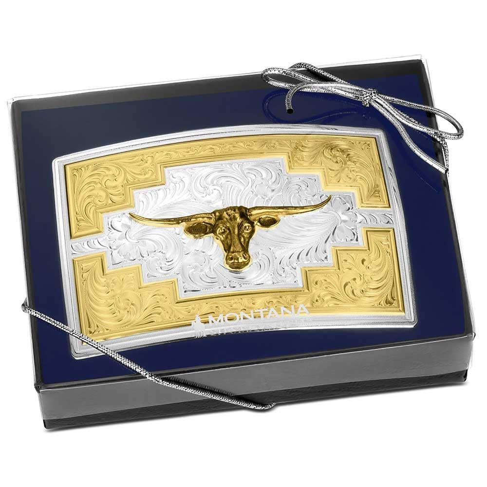 Gold and silver longhorn cattle design in a decorative box with 'J.E. Montana' branding.