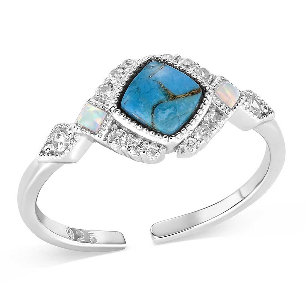 Silver ring with a blue stone and opal-like stones on a white background