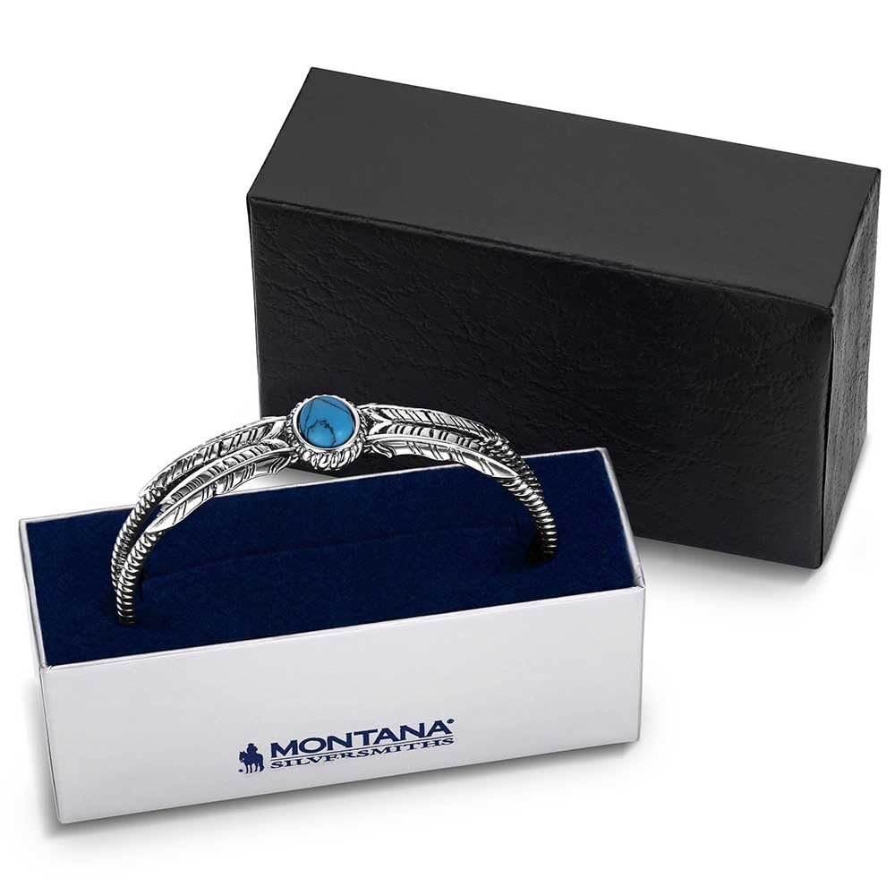 Silver bracelet with a blue gemstone in a Montana Silversmiths box.