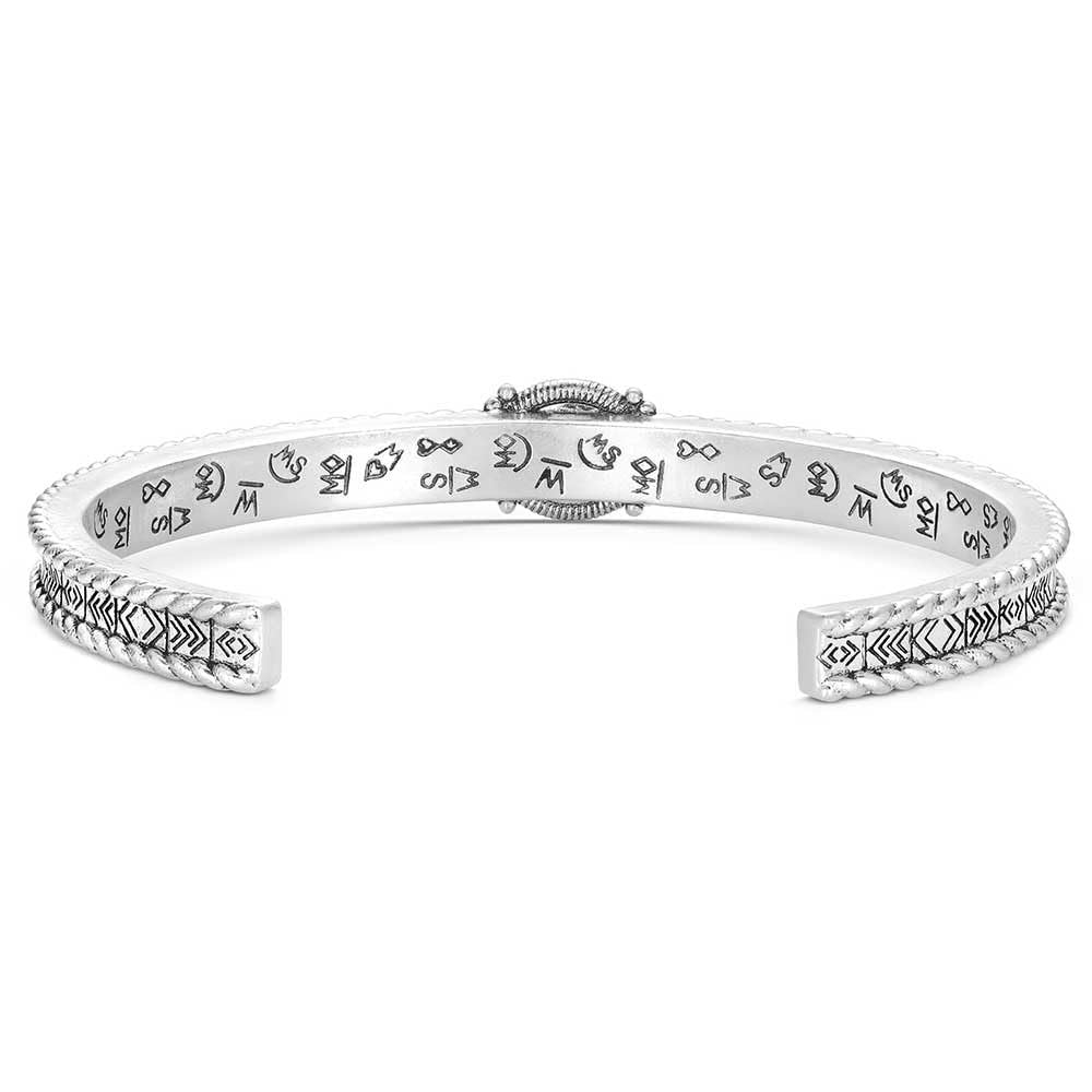 
                  
                    Silver bracelet with engraved patterns on a white background
                  
                